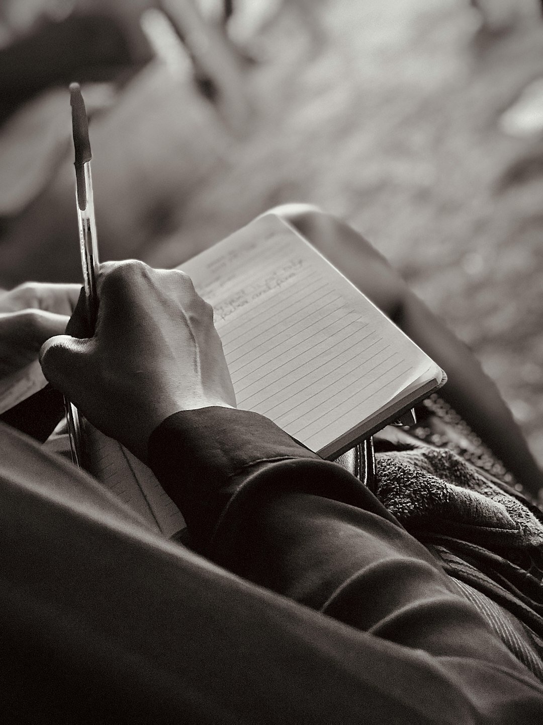 woman writing goals in notebook